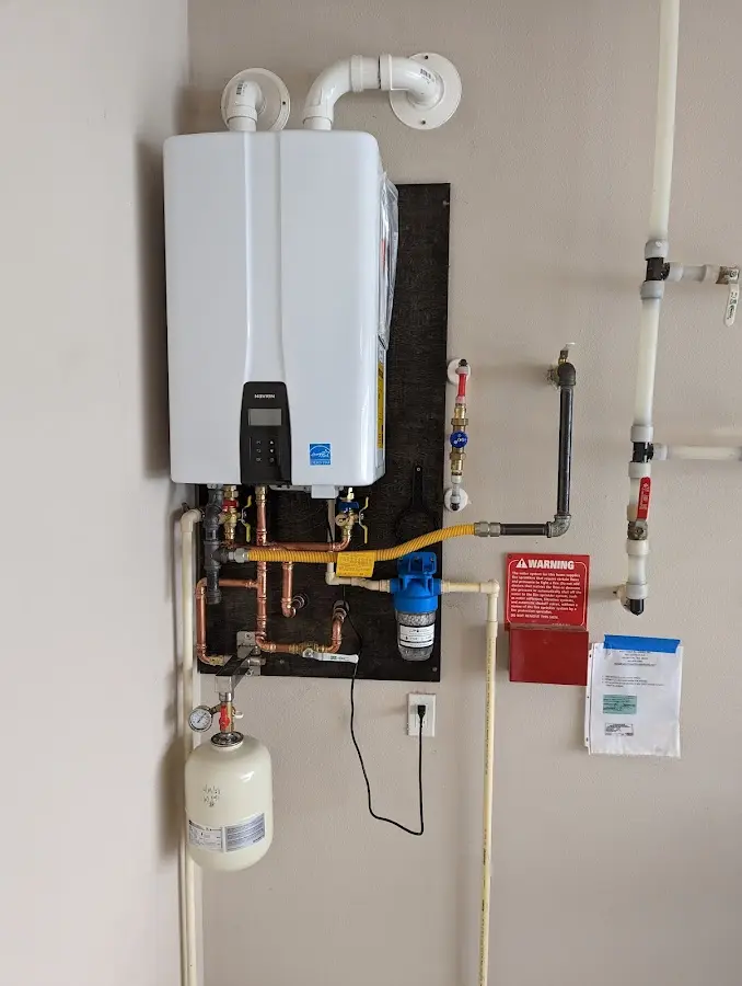 Professional plumber installing copper piping in a Poquoson home